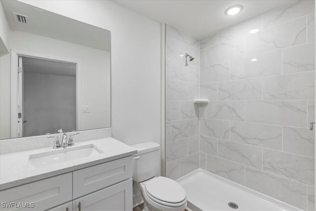 1904 NW 18th St, Cape Coral, FL 33993 - bathroom with visible vents, vanity, toilet, tiled shower, and recessed lighting