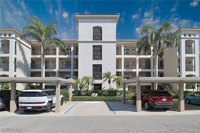 4690 Turnberry Lake Dr Unit 104, Estero, FL 33928 - view of building exterior featuring covered and uncovered parking