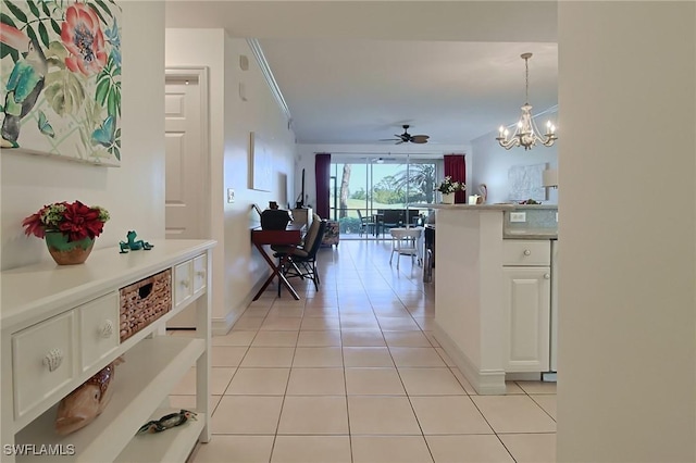 4690 Turnberry Lake Dr Unit 104, Estero, FL 33928 - hallway featuring light tile patterned floors, baseboards, ornamental molding, and a notable chandelier