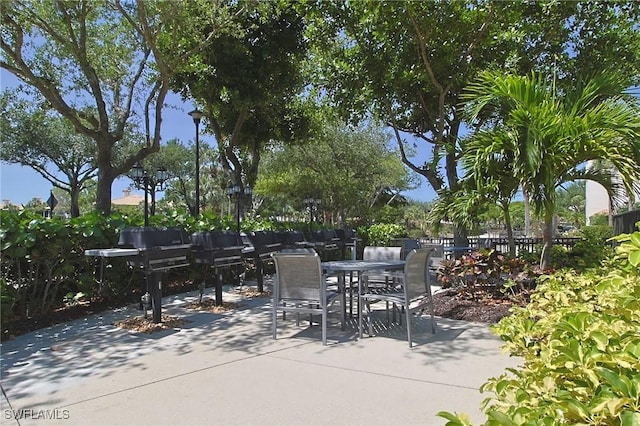 4690 Turnberry Lake Dr Unit 104, Estero, FL 33928 - view of patio featuring outdoor dining space, fence, and area for grilling