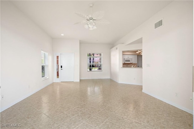 25073 Peacock Ln Unit 102, Naples, FL 34114 - unfurnished living room featuring healthy amount of natural light, ceiling fan, baseboards, and recessed lighting