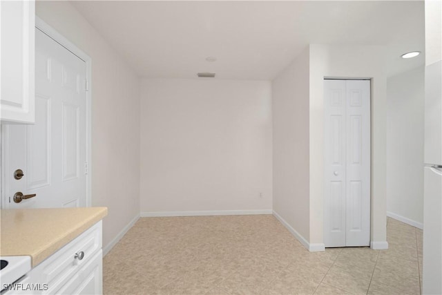 25073 Peacock Ln Unit 102, Naples, FL 34114 - unfurnished room with baseboards and recessed lighting