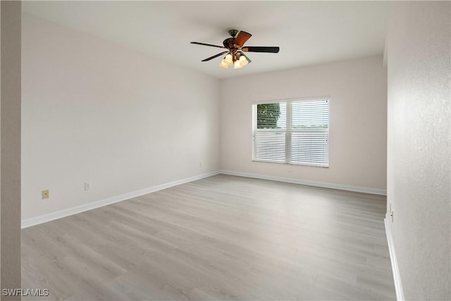 25073 Peacock Ln Unit 102, Naples, FL 34114 - spare room with light wood finished floors, ceiling fan, and baseboards