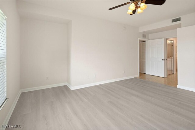 25073 Peacock Ln Unit 102, Naples, FL 34114 - unfurnished bedroom featuring light wood-type flooring, baseboards, and a ceiling fan
