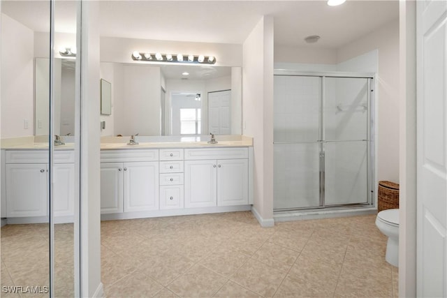 25073 Peacock Ln Unit 102, Naples, FL 34114 - bathroom featuring a stall shower, double vanity, toilet, and tile patterned flooring