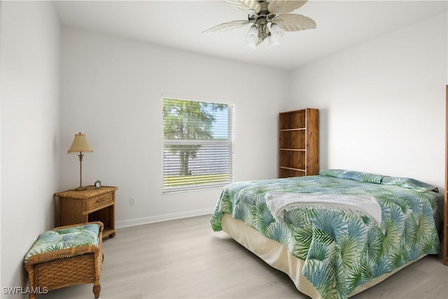 25073 Peacock Ln Unit 102, Naples, FL 34114 - bedroom with wood finished floors, baseboards, and ceiling fan