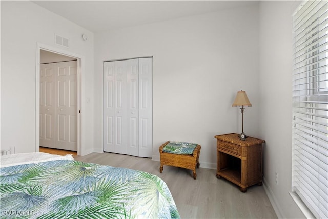 25073 Peacock Ln Unit 102, Naples, FL 34114 - bedroom featuring wood finished floors, baseboards, and a closet