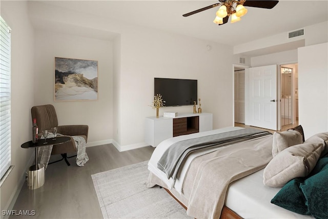 25073 Peacock Ln Unit 102, Naples, FL 34114 - bedroom with wood finished floors, baseboards, and a ceiling fan