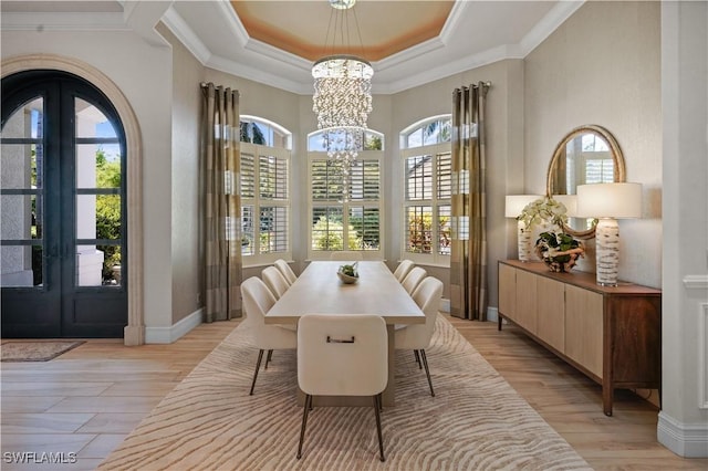 10371 Via Anacapri Ct, Miromar Lakes, FL 33913 - dining space featuring a chandelier, french doors, a raised ceiling, and ornamental molding