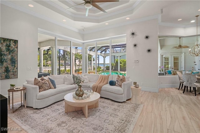 10371 Via Anacapri Ct, Miromar Lakes, FL 33913 - living area featuring a sunroom, a wealth of natural light, and ceiling fan with notable chandelier
