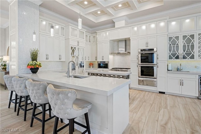 10371 Via Anacapri Ct, Miromar Lakes, FL 33913 - kitchen with a sink, crown molding, a warming drawer, wall chimney range hood, and appliances with stainless steel finishes