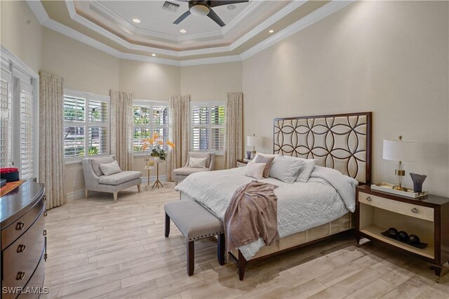 10371 Via Anacapri Ct, Miromar Lakes, FL 33913 - bedroom featuring a raised ceiling, light wood-style flooring, crown molding, and a towering ceiling