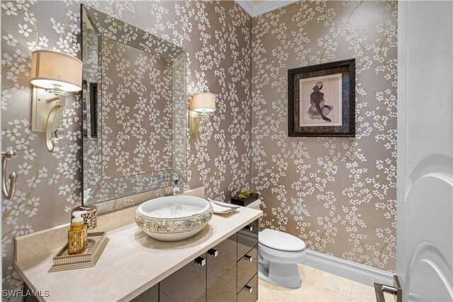 10371 Via Anacapri Ct, Miromar Lakes, FL 33913 - bathroom with vanity, toilet, baseboards, and wallpapered walls
