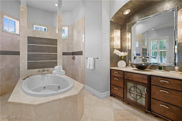 10371 Via Anacapri Ct, Miromar Lakes, FL 33913 - full bathroom with vanity, a whirlpool tub, plenty of natural light, and tile patterned floors