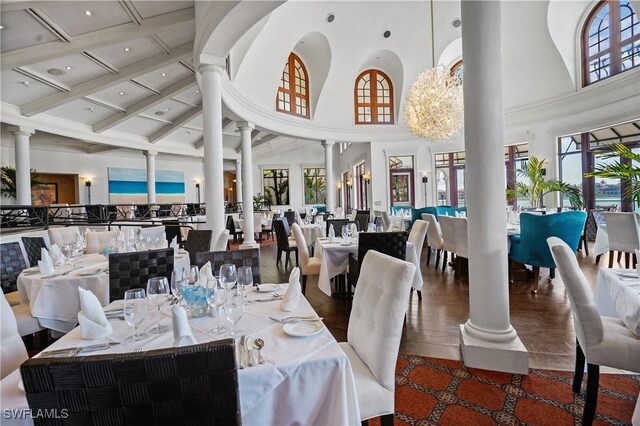 10371 Via Anacapri Ct, Miromar Lakes, FL 33913 - dining space featuring beam ceiling, decorative columns, and high vaulted ceiling
