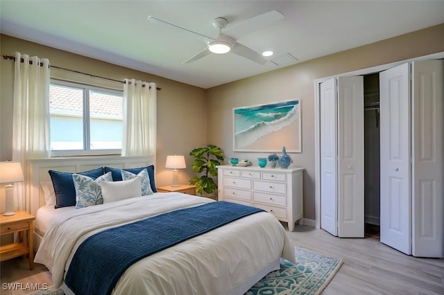 bedroom with a closet, a ceiling fan, and light wood-style floors