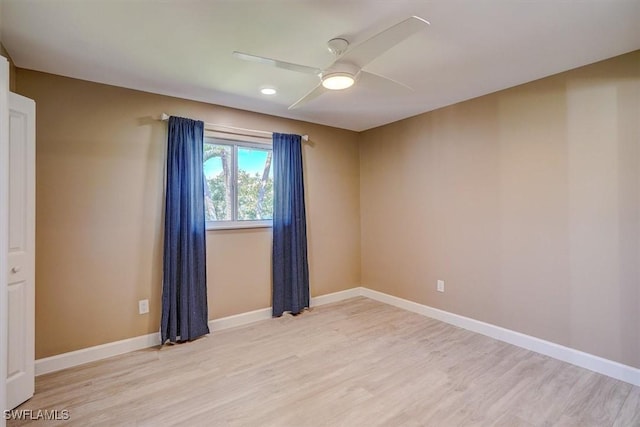 empty room with light wood-type flooring, baseboards, and ceiling fan