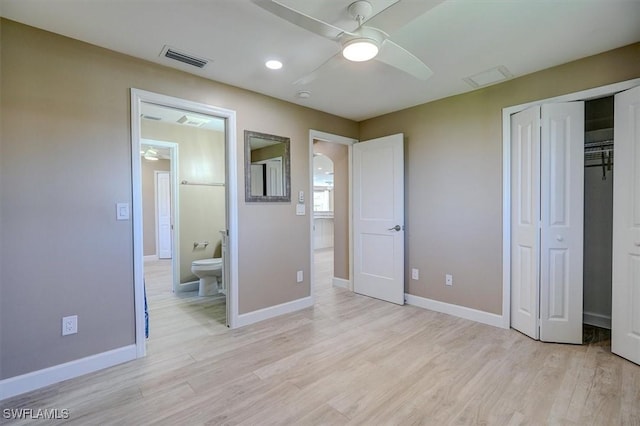 unfurnished bedroom with light wood-type flooring, baseboards, visible vents, and a closet