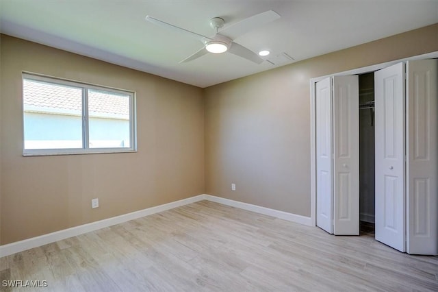unfurnished bedroom with a closet, baseboards, a ceiling fan, and light wood-type flooring