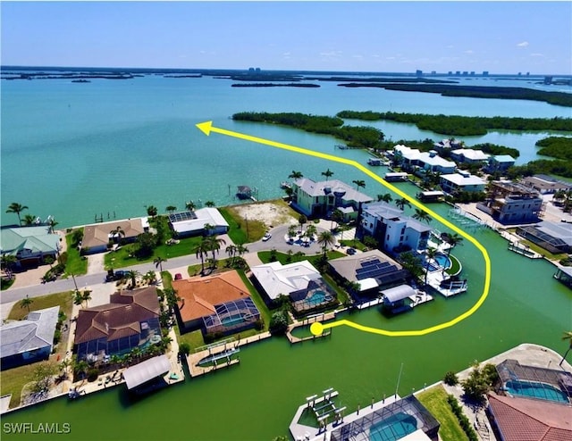 drone / aerial view with a water view and a residential view