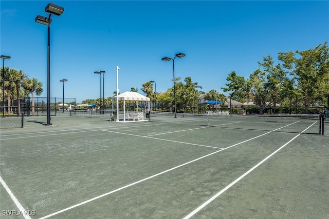 view of tennis court featuring fence