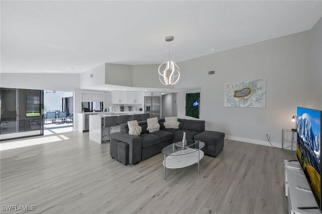 2723 SW 5th Ave, Cape Coral, FL 33914 - living room with light wood-style flooring, vaulted ceiling, and baseboards