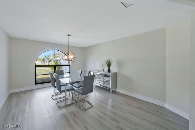 2723 SW 5th Ave, Cape Coral, FL 33914 - dining room featuring wood finished floors, a chandelier, and baseboards