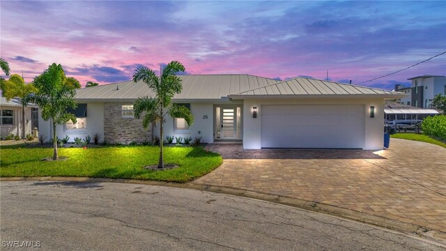 25 Palmview Blvd, Fort Myers Beach, FL 33931 - single story home featuring metal roof, a front yard, a garage, decorative driveway, and stucco siding