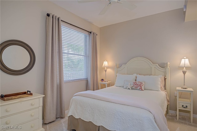 bedroom with baseboards, ceiling fan, and light carpet