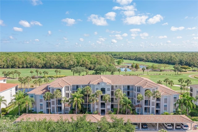 birds eye view of property featuring a water view, a wooded view, and golf course view