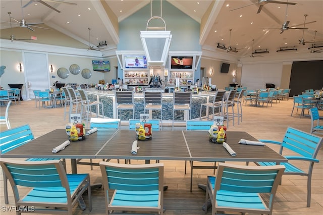 dining area featuring high vaulted ceiling and ceiling fan
