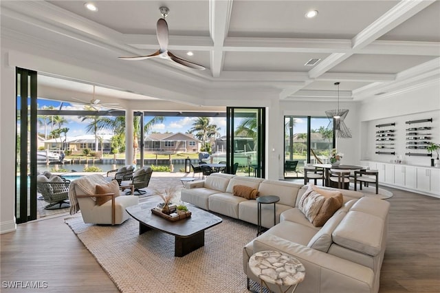 living area featuring a ceiling fan, beamed ceiling, wood finished floors, and coffered ceiling