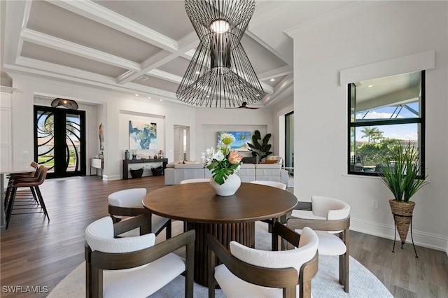 dining space featuring wood finished floors, beamed ceiling, baseboards, recessed lighting, and a chandelier