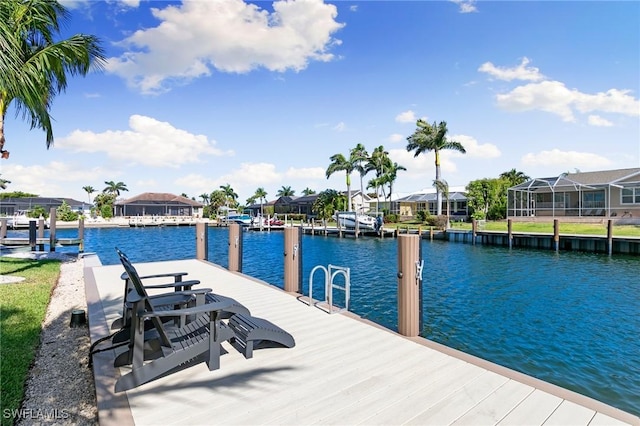 dock area featuring a water view and a residential view