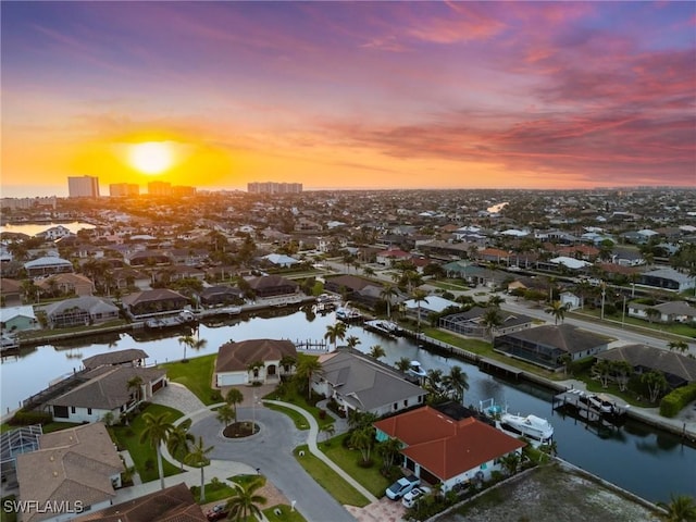 drone / aerial view featuring a water view and a residential view