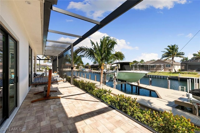 view of swimming pool with a boat dock, glass enclosure, boat lift, and a water view