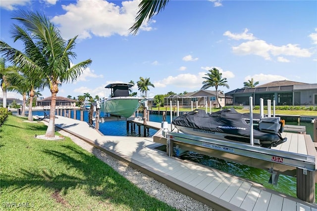 dock area with a lawn, a water view, boat lift, and a residential view