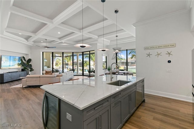kitchen with gray cabinets, a sink, beverage cooler, coffered ceiling, and dark wood-type flooring