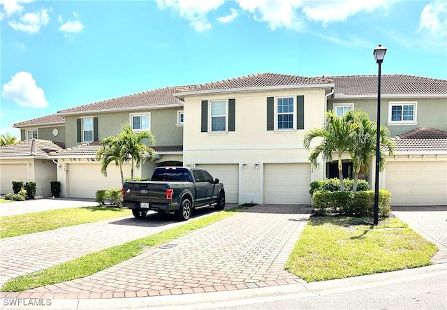 3779 Crofton Ct, Fort Myers, FL 33916 - view of property with driveway, stucco siding, a tile roof, and an attached garage