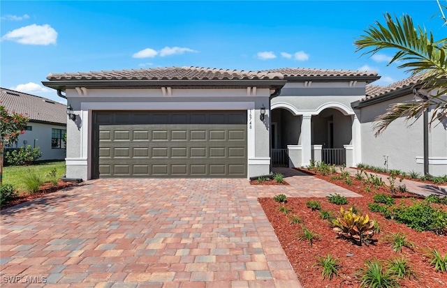 16748 Rolling Rock Blvd, Alva, FL 33920 - mediterranean / spanish home featuring decorative driveway, a tile roof, stucco siding, and an attached garage