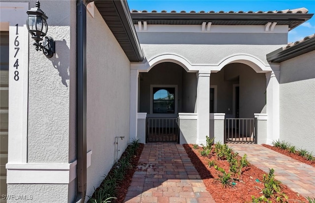 16748 Rolling Rock Blvd, Alva, FL 33920 - view of exterior entry with stucco siding and a gate