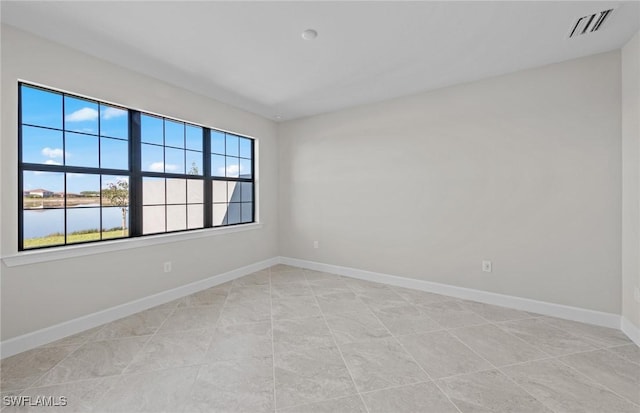 16748 Rolling Rock Blvd, Alva, FL 33920 - empty room featuring baseboards, a water view, and light tile patterned floors