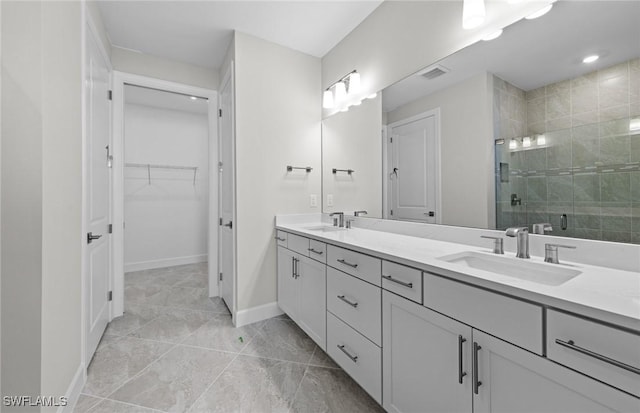 16748 Rolling Rock Blvd, Alva, FL 33920 - bathroom featuring a shower stall, baseboards, double vanity, a walk in closet, and marble finish flooring