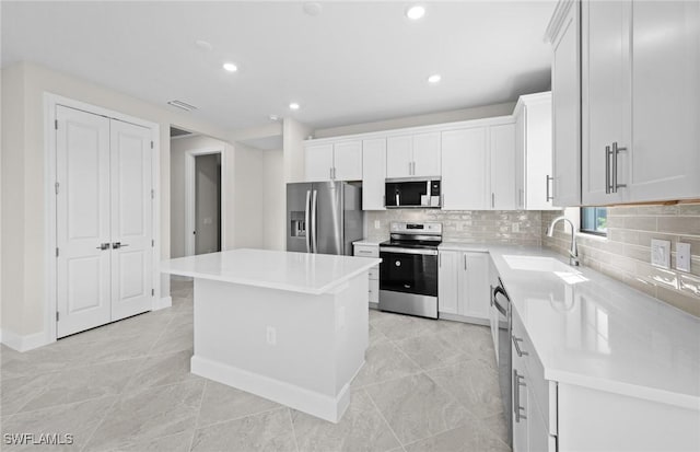 16748 Rolling Rock Blvd, Alva, FL 33920 - kitchen with stainless steel appliances, a sink, a center island, tasteful backsplash, and recessed lighting