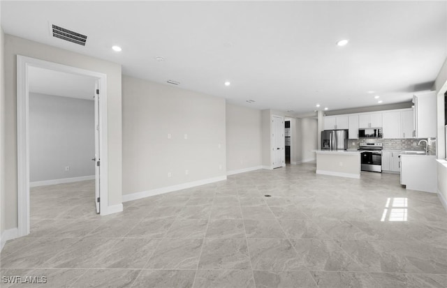 16748 Rolling Rock Blvd, Alva, FL 33920 - unfurnished living room featuring a sink, recessed lighting, and baseboards