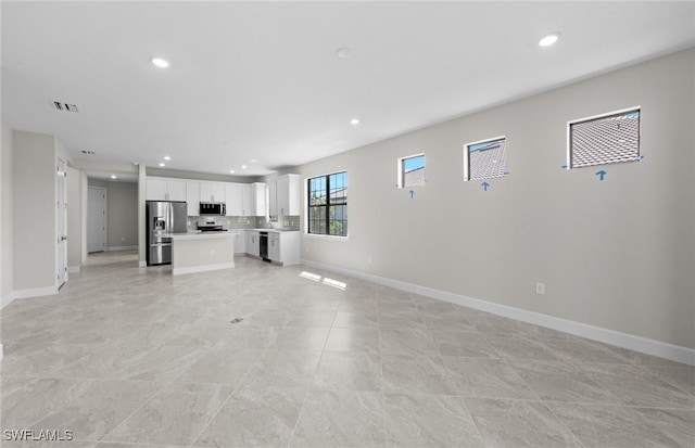 16748 Rolling Rock Blvd, Alva, FL 33920 - unfurnished living room featuring baseboards and recessed lighting