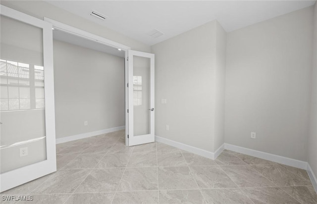 16748 Rolling Rock Blvd, Alva, FL 33920 - spare room with baseboards, light tile patterned flooring, and french doors