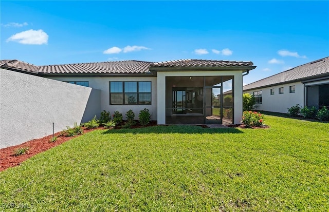 16748 Rolling Rock Blvd, Alva, FL 33920 - rear view of property featuring stucco siding, a sunroom, a yard, and a tiled roof