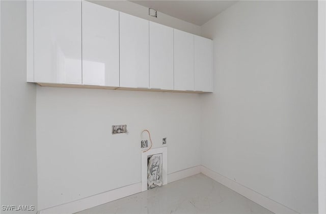 laundry area with washer hookup, baseboards, cabinet space, and marble finish floor