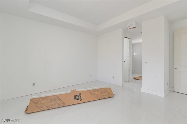 spare room with marble finish floor